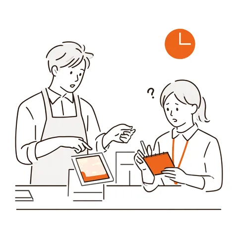 先輩スタッフがタブレットを見せながら新人に教えている